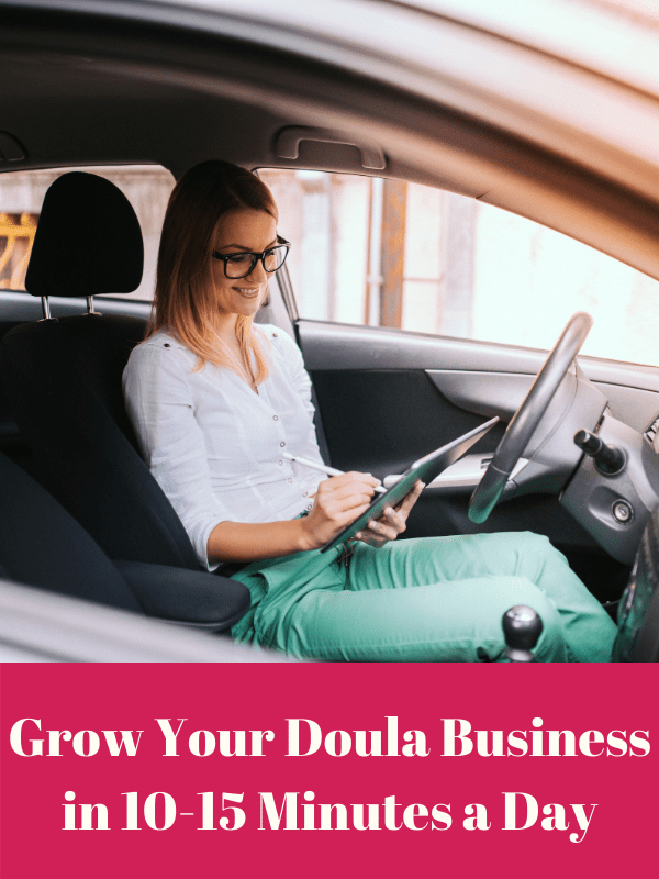 A woman working on her doula business in a car