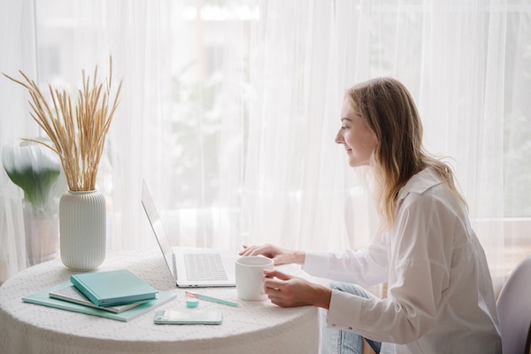 Women sitting at a table with her computer.