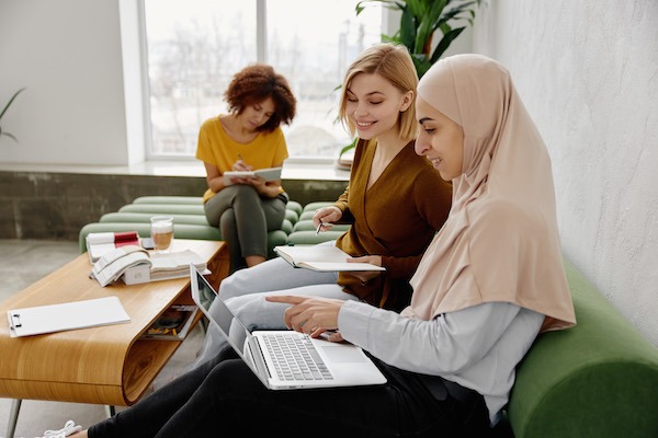 Three doulas sitting around working on their business.